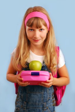 Schoolgirl with lunch box and apple clipart