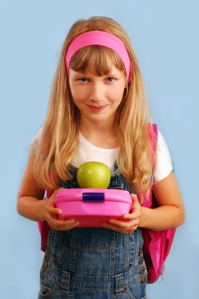 Schoolgirl with lunch box and apple — Stock Photo, Image