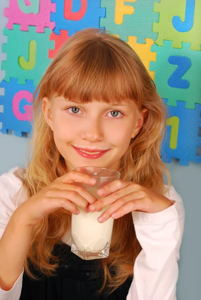 Schoolgirl with glass of milk — Stock Photo, Image