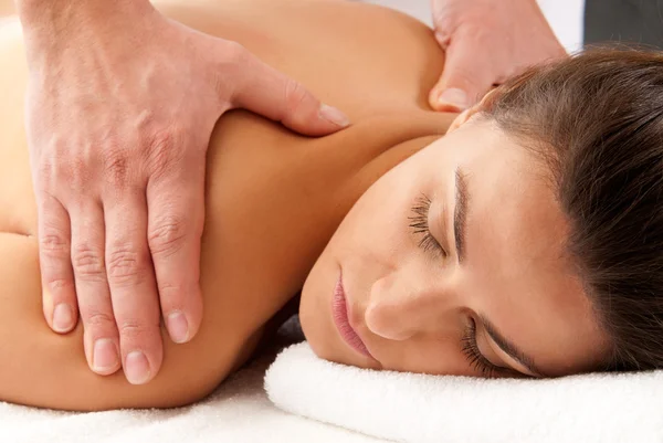 Woman receiving massage relax treatment close-up portrait from male hands — Stock Photo, Image