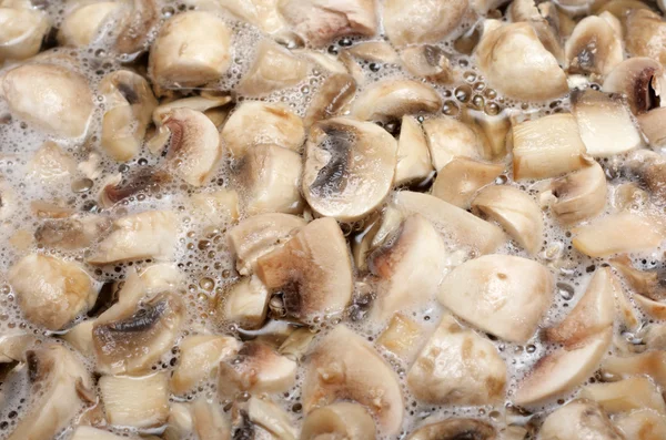 Boiling water with mushrooms, background — Stock Photo, Image