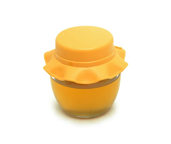 Natuurlijke honing in een glazen pot, geïsoleerd — Stockfoto