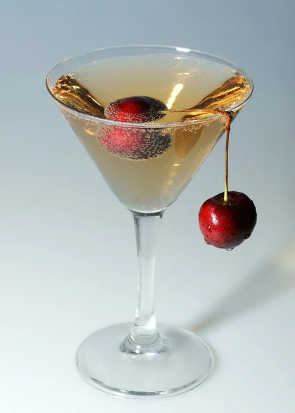 Cherry in a glass with champagne — Stock Photo, Image