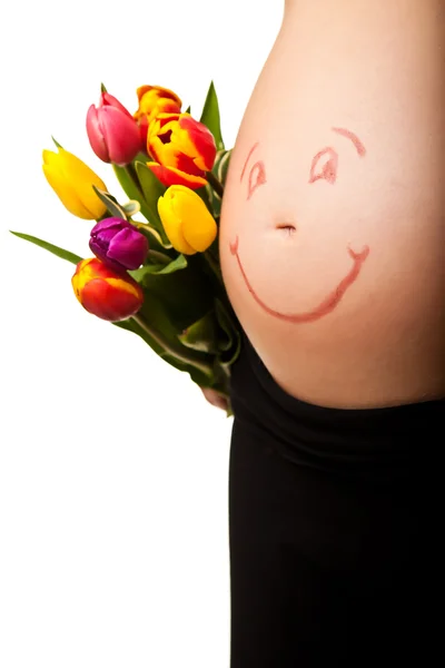 Těhotná žena břicho s tulipánem květiny — Stock fotografie