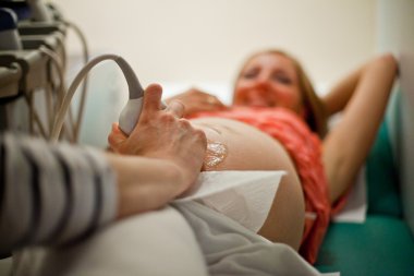 Ultrasonic diagnostic of pregnant woman clipart