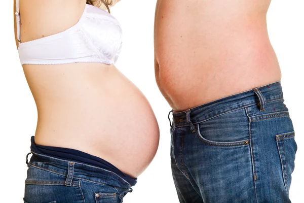 Man och gravid kvinna magar — Stockfoto