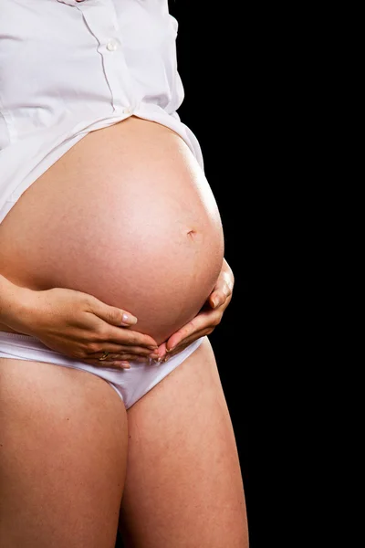 Wanita hamil di latar belakang hitam — Stok Foto