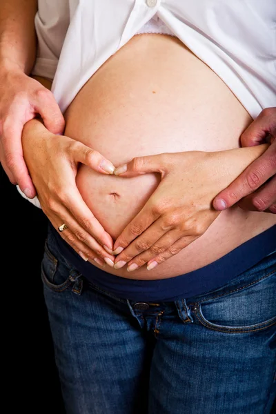 Mujer embarazada sobre fondo negro — Foto de Stock