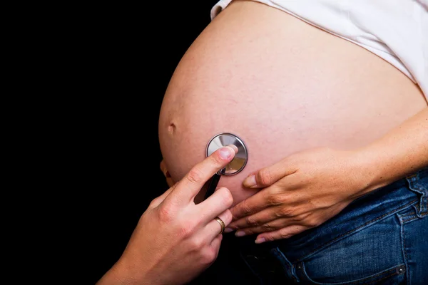 Gravid kvinna på svart bakgrund — Stockfoto