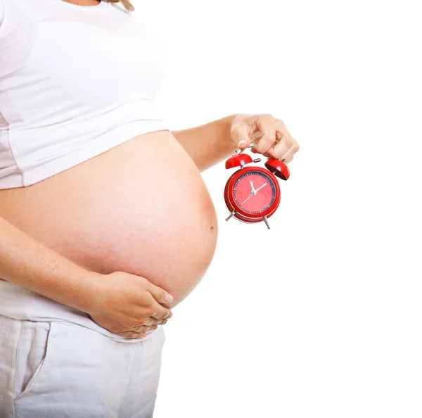 Pregnant woman with clock isolated on white — Stock Photo, Image
