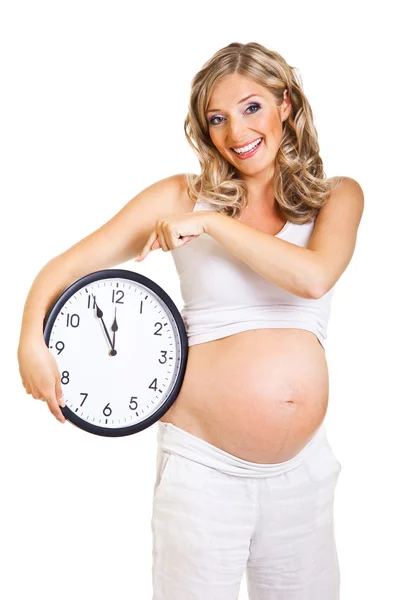 Pregnant woman with clock isolated on white Stock Picture