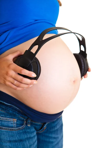 Mujer embarazada con auriculares aislados en blanco —  Fotos de Stock