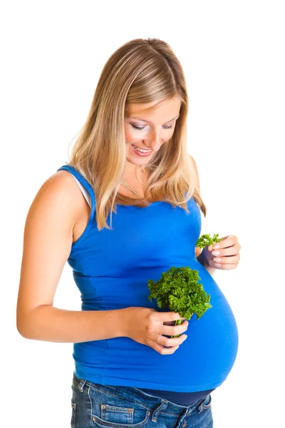 Беременная женщина с петрушкой изолированы на белом — стоковое фото