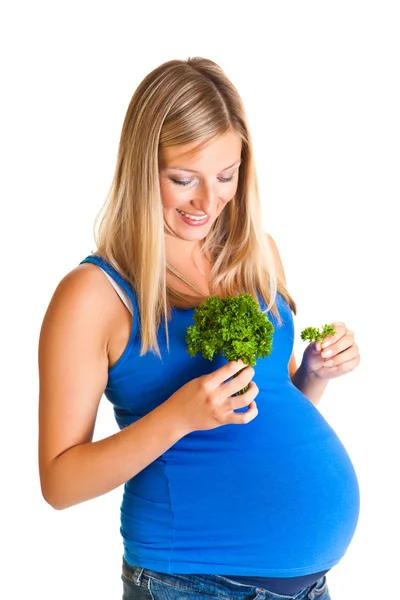 Zwangere vrouw met peterselie geïsoleerd op wit — Stockfoto