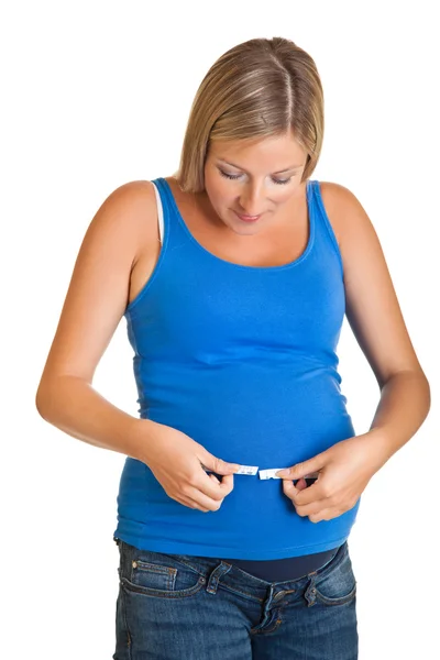 Беременная женщина измеряет желудок, изолированный на белом — стоковое фото
