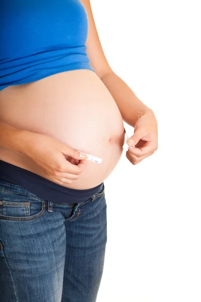 Pregnant woman measuring stomach isolated on white — Stock Photo, Image