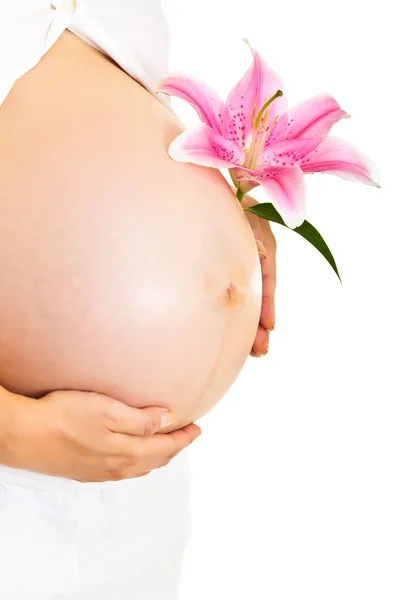Těhotná žena držící že Lillies izolovaných na bílém — Stock fotografie