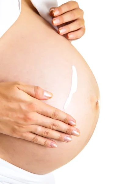Mujer embarazada hidratante vientre para evitar estrías aisladas en blanco —  Fotos de Stock
