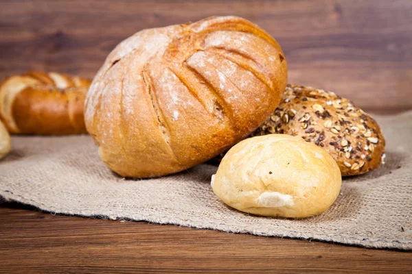 stock image Composition of fresh bread on wood