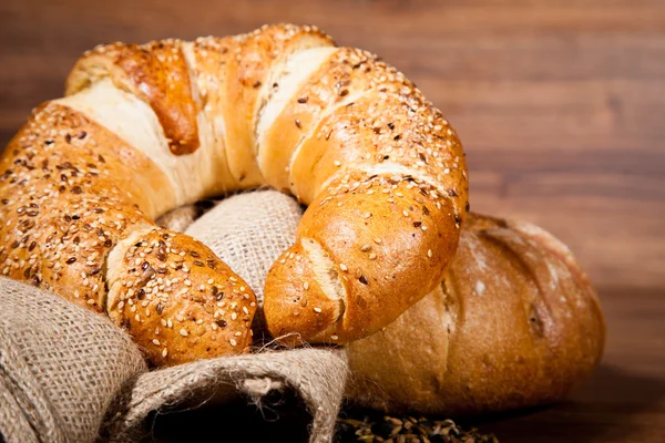 stock image Composition of fresh bread on wood