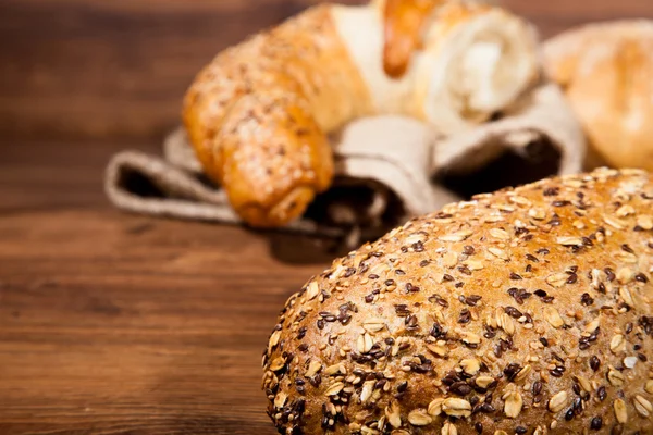 stock image Composition of fresh bread on wood