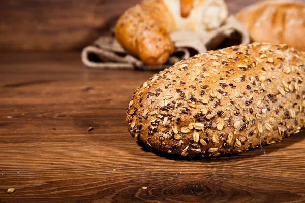 stock image Composition of fresh bread on wood