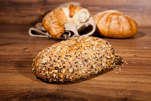 stock image Composition of fresh bread on wood