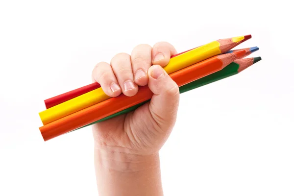 The children's hand holds colour pencils — Stock Photo, Image