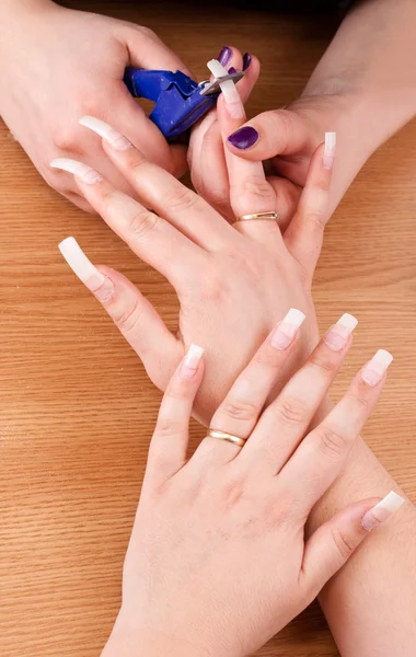 Manicurist trimming nail — Stock Photo, Image