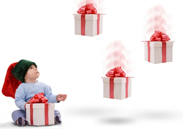 Niño con regalos cayendo — Foto de Stock