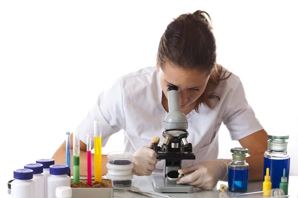 Woman working with a microscope — Stock Photo, Image