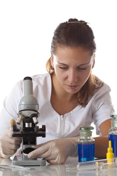 Woman setting with a microscope — Stock Photo, Image