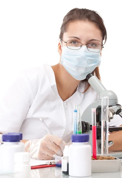 Woman working with a microscope — Stock Photo, Image