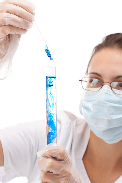 Female chemist using test tubes