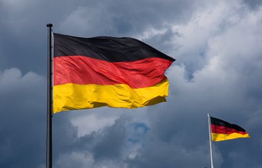 German flags in front of dark clouds clipart