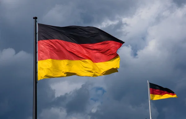 German flags in front of dark clouds — Stock Photo, Image