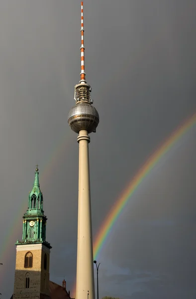 Rainbows, television tower and church — Stock Photo, Image