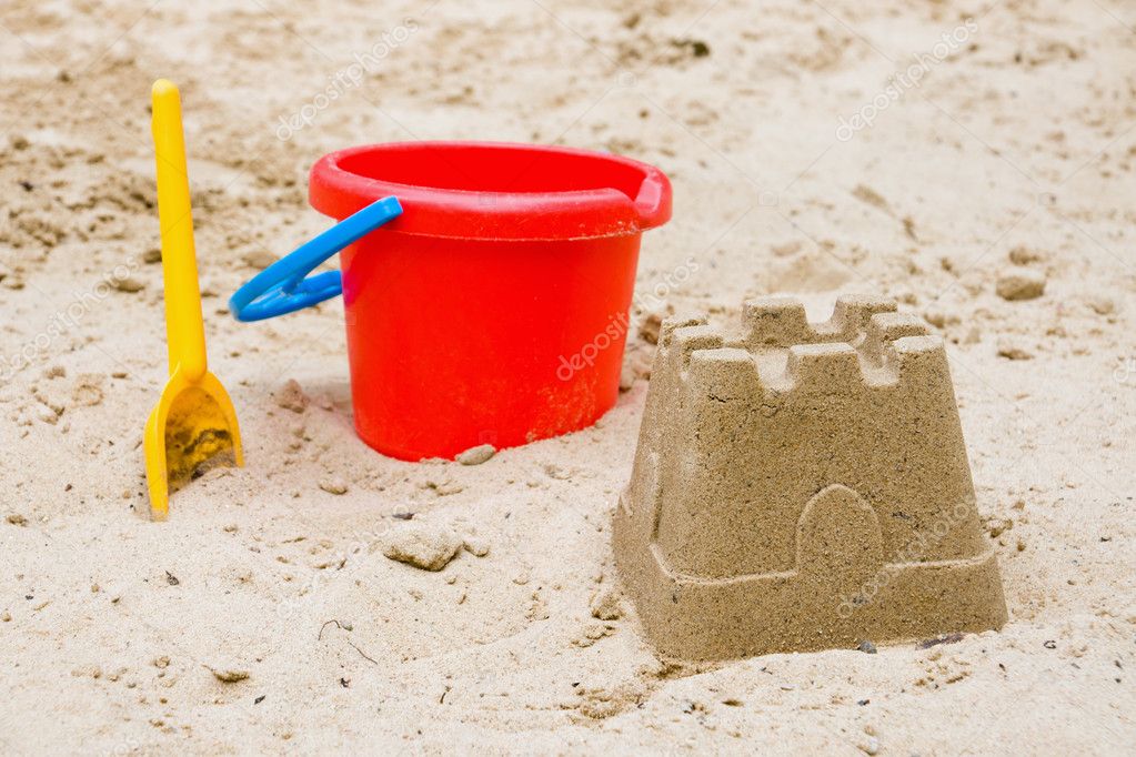 Sandcastle with bucket and shovel Stock Photo by ©elxeneize 5973923