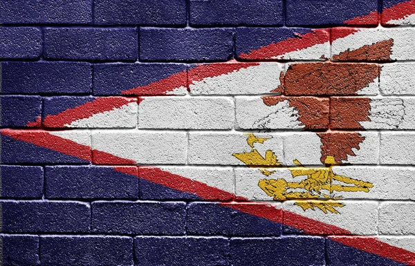 Amerikanska Samoas flagga på tegelvägg — Stockfoto