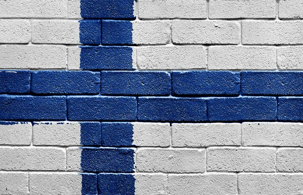 Finlandiya bayrağı tuğla duvar — Stok fotoğraf