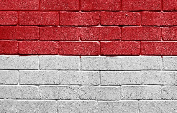 Flagge von Monaco an Ziegelmauer — Stockfoto