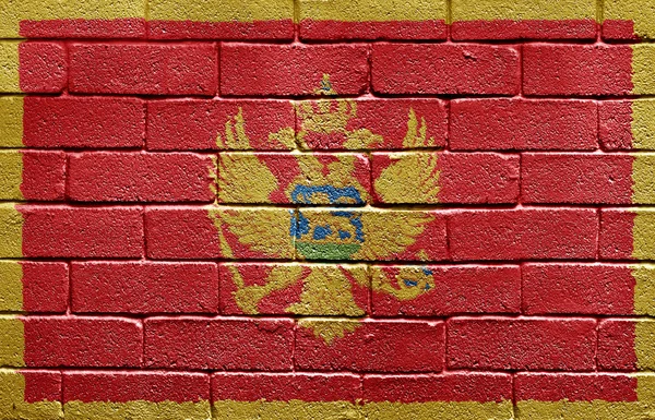 Flag of Montenegro on brick wall — Stock Photo, Image