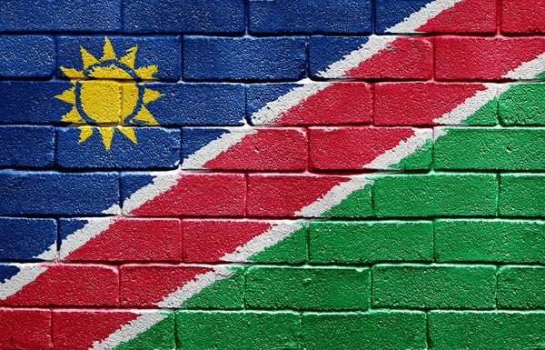 Vlajka Namibie na cihlovou zeď — Stock fotografie