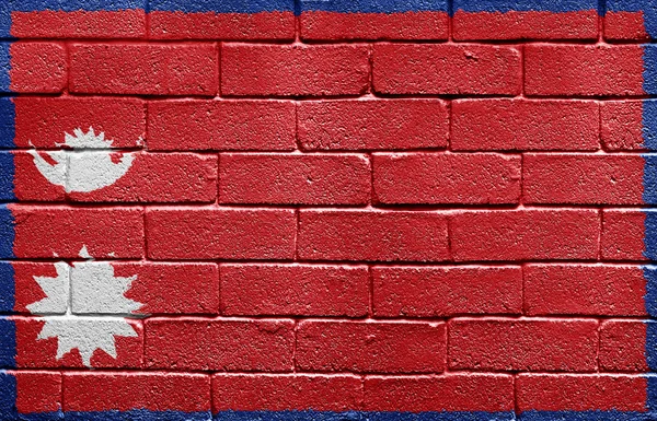 Vlajka Nepálu na cihlovou zeď — Stock fotografie
