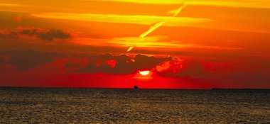 Mystery sunset over Red sea. Sun, colorful sky and clouds over dark sea clipart