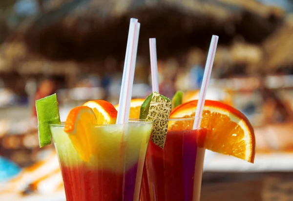 Cocktails from fresh fruit in a tall glass with tubes — Stock Photo, Image