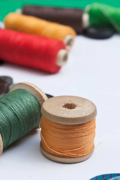 Thread with a needle and buttons — Stock Photo, Image