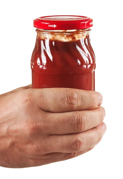 Jar tomato paste in hand — Stock Photo, Image