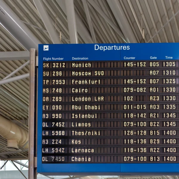 Airport departures information board — Stock Photo, Image