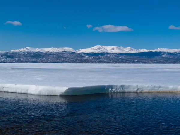 Montanhas nevadas no lago Laberge congelado, Yukon, Canadá — Fotografia de Stock